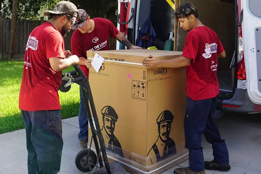 HVAC technicians unloading new AC unit for installation in Orange TX