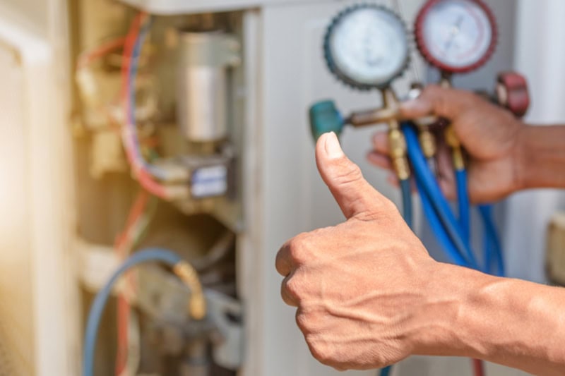 Give Your Marine HVAC in Texas Some TLC. Close up of Air Conditioning Repair, repairman on the floor fixing air conditioning system.